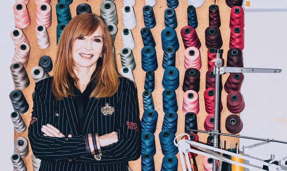Nicole Miller in front of a wall of thread spools