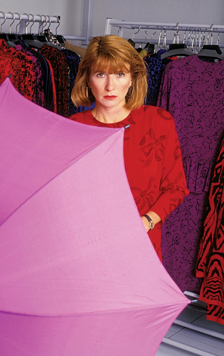 Nicole Miller holding a pink umbrella among her collection